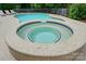Close up of a stone, in-ground hot tub connected to a larger pool at 2725 Cotton Planter Ln, Charlotte, NC 28270