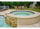 Close up of a stone, in-ground hot tub with waterfall feature at 2725 Cotton Planter Ln, Charlotte, NC 28270