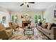 Cozy living room featuring a fireplace, neutral-toned furniture, and lots of natural light at 2725 Cotton Planter Ln, Charlotte, NC 28270
