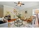 Warm and inviting living room featuring hardwood floors, neutral decor, and a staircase at 2725 Cotton Planter Ln, Charlotte, NC 28270