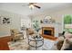 Cozy living room featuring a fireplace, neutral-toned furniture, and lots of natural light at 2725 Cotton Planter Ln, Charlotte, NC 28270