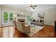 Cozy living room featuring a fireplace, hardwood floors, large windows and neutral decor at 2725 Cotton Planter Ln, Charlotte, NC 28270