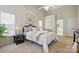 This main bedroom features plush carpet, a ceiling fan, and a charming view of the en suite bathroom at 2725 Cotton Planter Ln, Charlotte, NC 28270