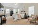 This main bedroom has plush carpet, ceiling fan, natural light, and a neutral color scheme at 2725 Cotton Planter Ln, Charlotte, NC 28270