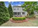 Aerial backyard view with an outdoor patio featuring a fire pit, seating, mature trees, and lush landscaping at 295 Helton Ln, Fort Mill, SC 29708