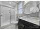 Bathroom features a glass-enclosed shower, a vanity with marble countertops, and a round mirror at 295 Helton Ln, Fort Mill, SC 29708