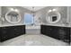 Luxurious bathroom with dual vanities, a soaking tub, decorative mirrors, and stylish lighting at 295 Helton Ln, Fort Mill, SC 29708