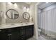 Bathroom featuring dual vanities, dark wood cabinets, round mirrors, and recessed lighting at 295 Helton Ln, Fort Mill, SC 29708