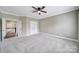 Spacious bedroom features neutral carpet, a ceiling fan, and access to a walk-in closet and bathroom at 295 Helton Ln, Fort Mill, SC 29708
