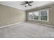 Spacious bedroom with neutral carpet, a ceiling fan, and a large window that provides natural light at 295 Helton Ln, Fort Mill, SC 29708