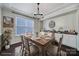 Dining room featuring a wooden table, upholstered chairs, a large window, and built-in storage at 295 Helton Ln, Fort Mill, SC 29708
