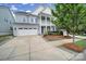 Charming two-story home with a welcoming front porch, landscaped yard, and a two-car garage at 295 Helton Ln, Fort Mill, SC 29708