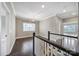 Hallway on the second floor with dark wood floors and white railings at 295 Helton Ln, Fort Mill, SC 29708