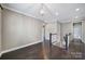 Hallway with dark hardwood floors and white molding along with a view of a staircase and doorways at 295 Helton Ln, Fort Mill, SC 29708