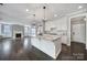 Bright kitchen with white cabinets, granite countertops, a large island, and stainless steel appliances at 295 Helton Ln, Fort Mill, SC 29708