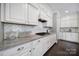 Close up of kitchen with granite countertops, white cabinets, gas cooktop, and decorative backsplash at 295 Helton Ln, Fort Mill, SC 29708
