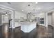 Spacious kitchen featuring white cabinetry, stainless steel appliances, a large center island, and modern lighting at 295 Helton Ln, Fort Mill, SC 29708
