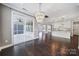 An open floorplan features a sunroom and a kitchen with white cabinets and an island with barstool seating at 295 Helton Ln, Fort Mill, SC 29708