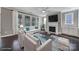 Bright living room with large windows, fireplace, and comfortable white seating arrangement with colorful rug at 295 Helton Ln, Fort Mill, SC 29708
