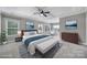 Spacious main bedroom with tray ceiling, ceiling fan, sitting area, and large windows at 295 Helton Ln, Fort Mill, SC 29708