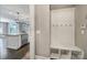 Hallway with a built-in mudroom bench, hooks, and storage cubbies, leading to an open kitchen area at 295 Helton Ln, Fort Mill, SC 29708