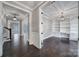 Open view of office space featuring dark hardwood floors, custom built-in shelving, and recessed lighting at 295 Helton Ln, Fort Mill, SC 29708