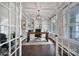 Modern office space with a wooden desk, built-in bookshelves, large windows, and a stylish light fixture at 295 Helton Ln, Fort Mill, SC 29708