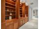 Bright hallway featuring custom built-in wooden bookshelves and cabinets under elegant crown molding at 2971 Kaneland Ct, Rock Hill, SC 29732