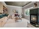 Sitting area with a marble fireplace, built-in shelving, large windows, and plush seating at 2971 Kaneland Ct, Rock Hill, SC 29732