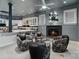 Relax in this living room with comfortable chairs, a fireplace, wet bar, and unique decorative features at 2971 Kaneland Ct, Rock Hill, SC 29732