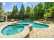 Backyard pool featuring a bridge, lounge seating, and a stone patio at 2971 Kaneland Ct, Rock Hill, SC 29732
