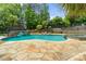 Backyard pool featuring a bridge, lounge seating, and a stone patio at 2971 Kaneland Ct, Rock Hill, SC 29732