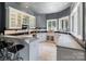 This stunning wet bar features custom cabinets, a wine rack, and a sink beneath large picture windows at 2971 Kaneland Ct, Rock Hill, SC 29732