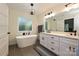 Elegant bathroom featuring a freestanding tub, double vanity, and modern finishes at 3020 Quiet Ln, Iron Station, NC 28080