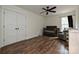 Bedroom featuring hardwood floors, a crib, ceiling fan and double door closet at 3020 Quiet Ln, Iron Station, NC 28080