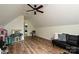 Attic bonus room features hardwood floors, high angled ceilings and a ceiling fan at 3020 Quiet Ln, Iron Station, NC 28080