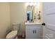 Charming half bathroom with modern fixtures, vanity, and a well-lit mirror at 3020 Quiet Ln, Iron Station, NC 28080