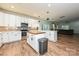 Well-designed kitchen with modern appliances, an island, and stylish lighting fixtures, open to the living area at 3020 Quiet Ln, Iron Station, NC 28080