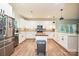 Bright kitchen featuring white cabinets, stainless steel appliances, butcher block island, and wood flooring at 3020 Quiet Ln, Iron Station, NC 28080