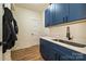 Convenient mud room with blue cabinets, sink, and storage, perfect for organization at 3020 Quiet Ln, Iron Station, NC 28080