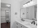 Bright bathroom featuring double sink vanity, modern fixtures, large mirror, and walk-in closet at 3103 Suggs St, Belmont, NC 28012