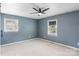 Bedroom features neutral carpet, two windows and neutral blue walls at 3103 Suggs St, Belmont, NC 28012