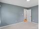 Cozy bedroom with carpeted floors, gray walls, and easy access to other rooms at 3103 Suggs St, Belmont, NC 28012