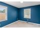 Bedroom with carpeted floors, blue walls, and natural light from two windows at 3103 Suggs St, Belmont, NC 28012