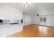 Bright living room with hardwood floors, white walls and modern ceiling fan. Features open access to the kitchen at 3103 Suggs St, Belmont, NC 28012