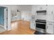 Updated kitchen with granite counters that opens to an open living space with hardwood floors and white walls at 3103 Suggs St, Belmont, NC 28012