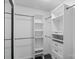 Walk-in closet with custom white shelving and drawers on dark wood floor at 3103 Suggs St, Belmont, NC 28012