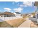 Backyard featuring a white fence and concrete patio surrounded by well-manicured lawn at 3105 Bonterra Blvd, Indian Trail, NC 28079