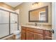 Well-lit bathroom featuring a granite countertop vanity and glass-enclosed shower at 3105 Bonterra Blvd, Indian Trail, NC 28079