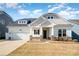 Attractive single-Gathering home features a well-maintained lawn, stone accents, and a two-car garage at 3105 Bonterra Blvd, Indian Trail, NC 28079